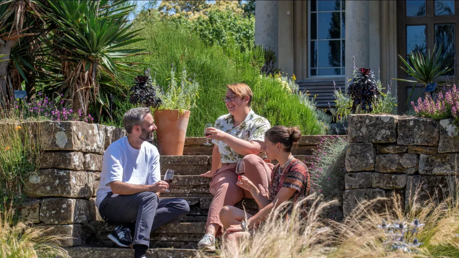 Wine walks, Mediterranean Garden at Kew © RBG Kew Three people enjoying a glass of wine in the Mediterranean Garden at Kew