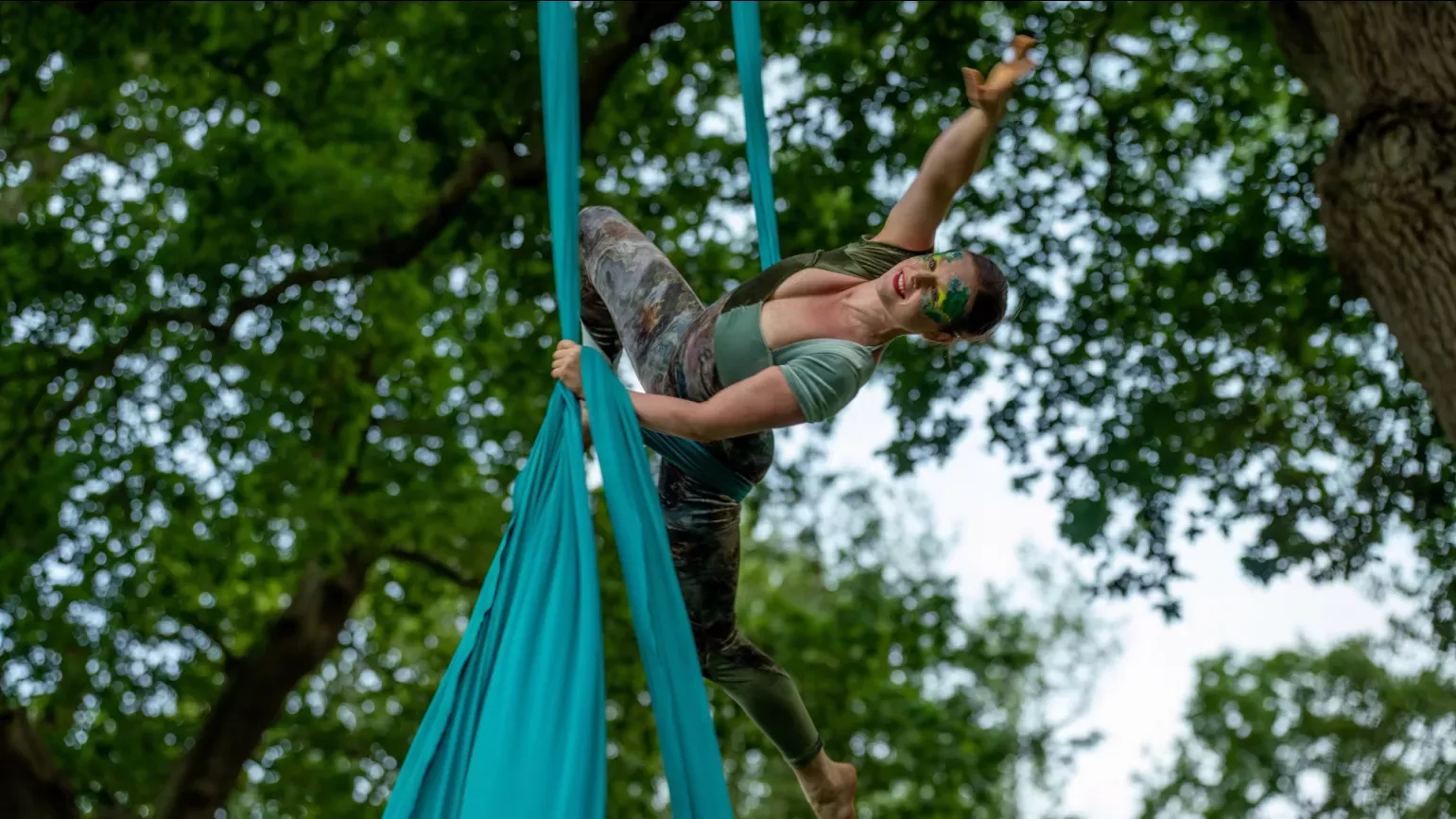 Wanderwild, Visual Air © RBG Kew A person on fabric strips dancing from a tree