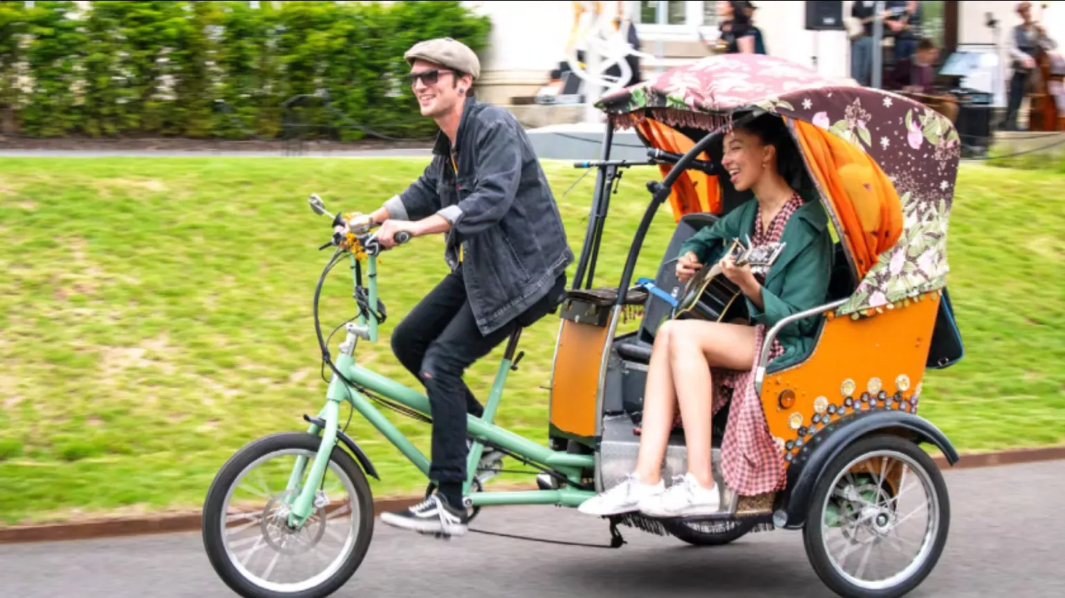 Summer Cycle © RBG Kew A person on a cycle rickshaw with a passenger playing the guitar
