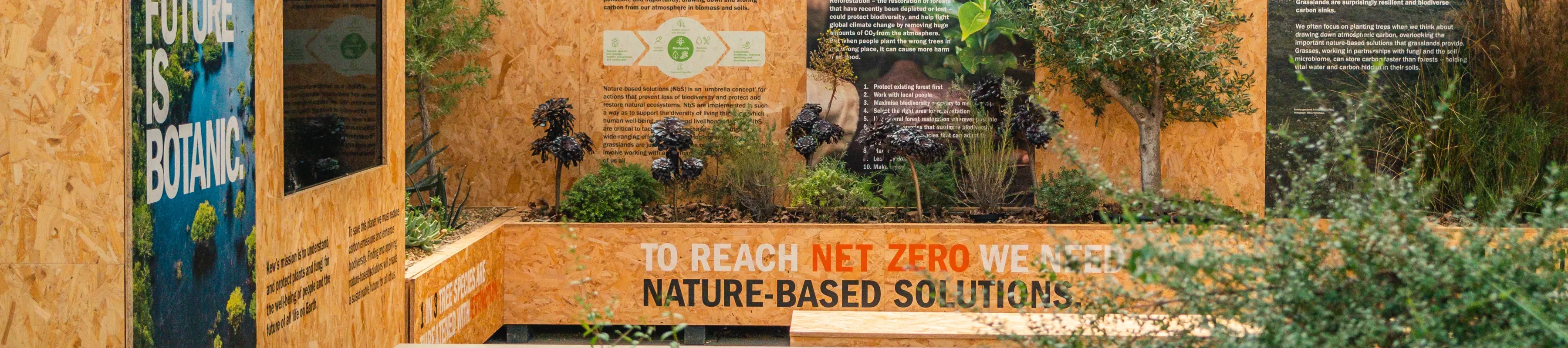 COP26 display at Wakehurst, Visual Air © RBG Kew Informative wooden panels surrounded by plants