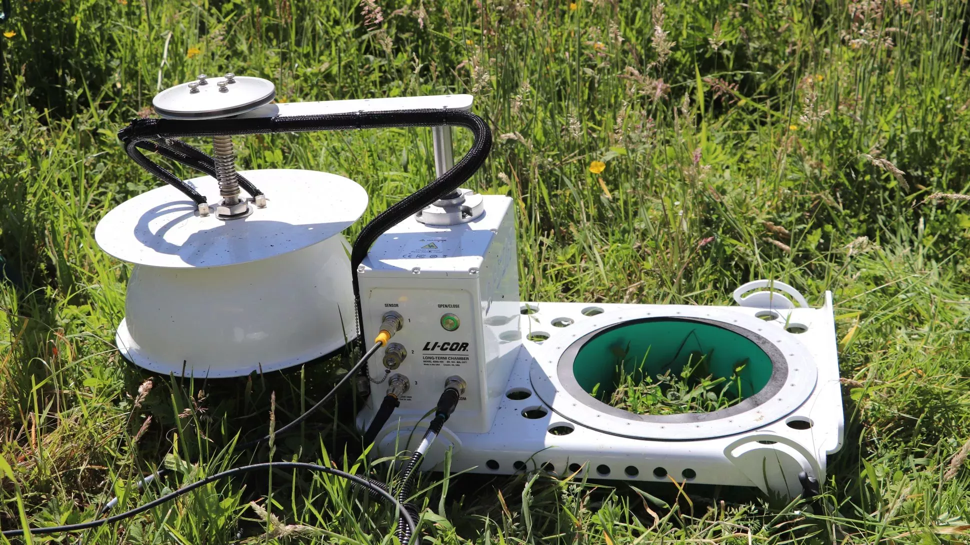 A permanent monitoring chamber © RBG Kew A piece of white scientific machinery in a field