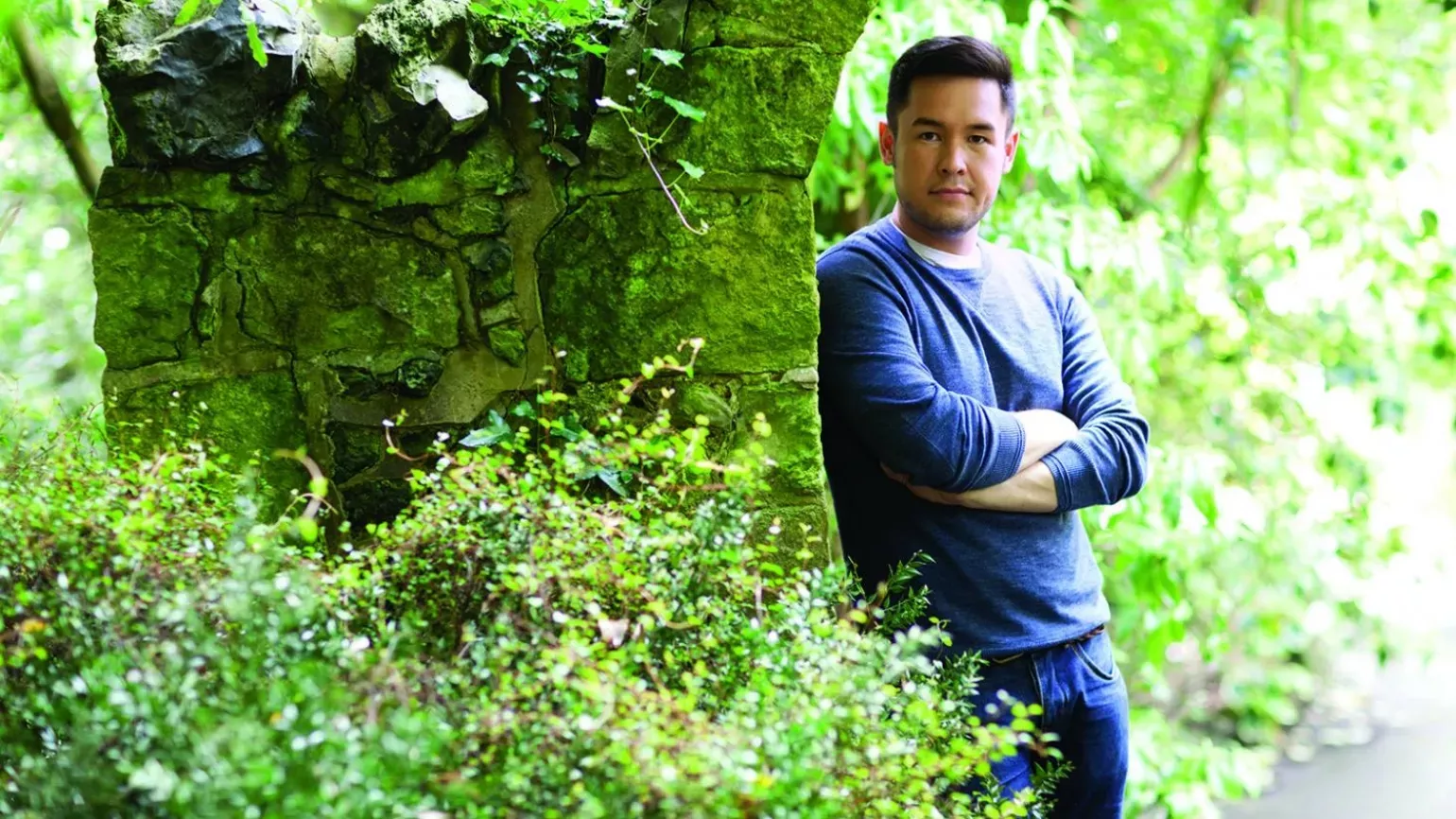 James Wong, Ethnobotanist and TV presenter © Patrick Drummond Man leaning against a tree