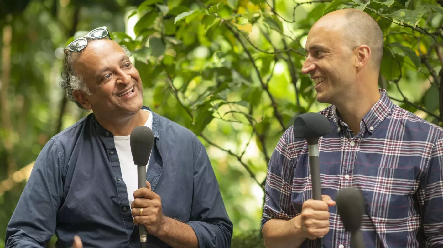 Unearthed guests Alex Antonelli and Ajay Chhabra © RBG Kew Two men sitting in the Palm House speaking into microphones