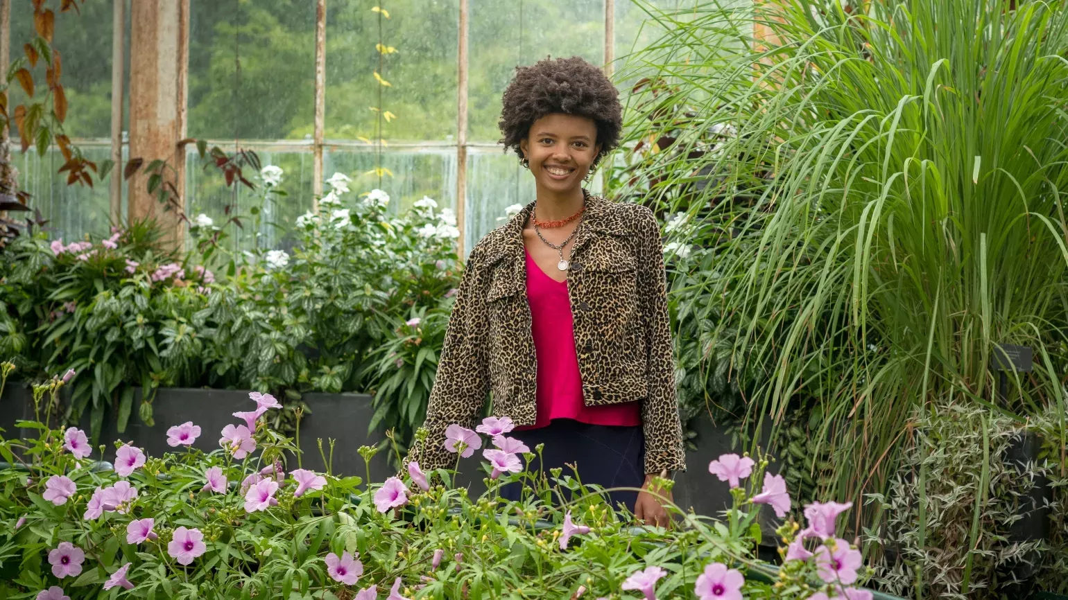 Unearthed Presenter Poppy Okocha, Ecological Food Grower © RBG Kew Woman standing amongst plants at Kew