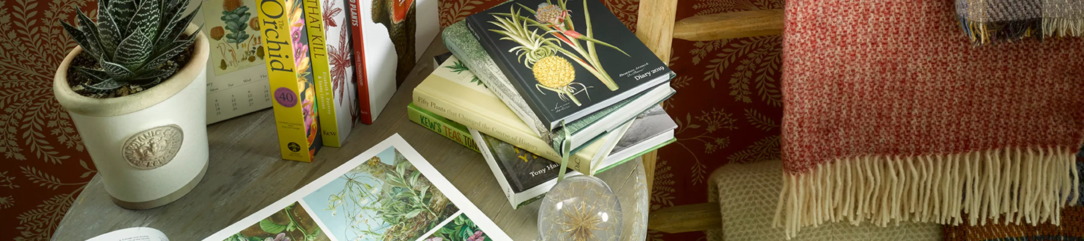 Kew products available to buy ©RBG Kew Books pulled on a coffee table along with a collection of Kew products