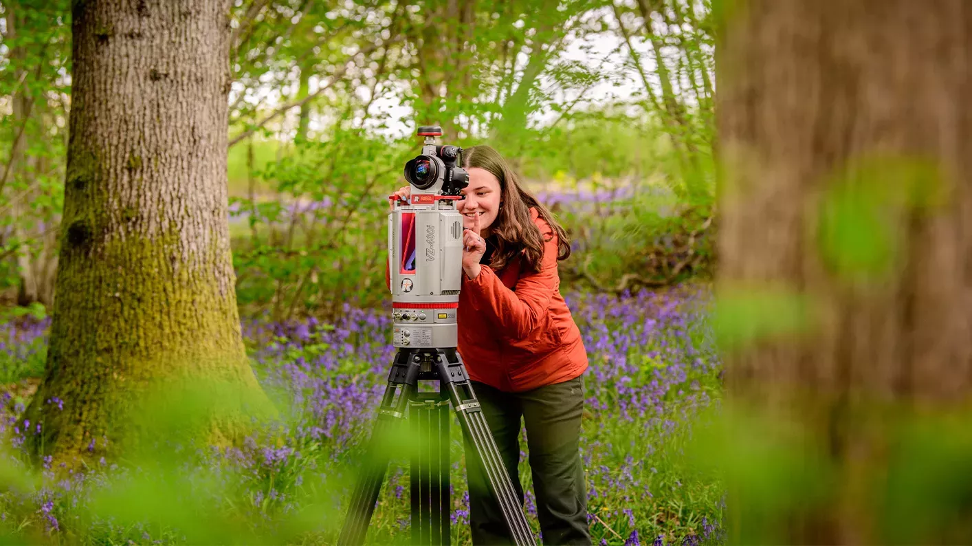 LiDAR scanning, Jim Holden © RBG Kew A scientist stands in a field of bluebells, next to a LiDAR scanner