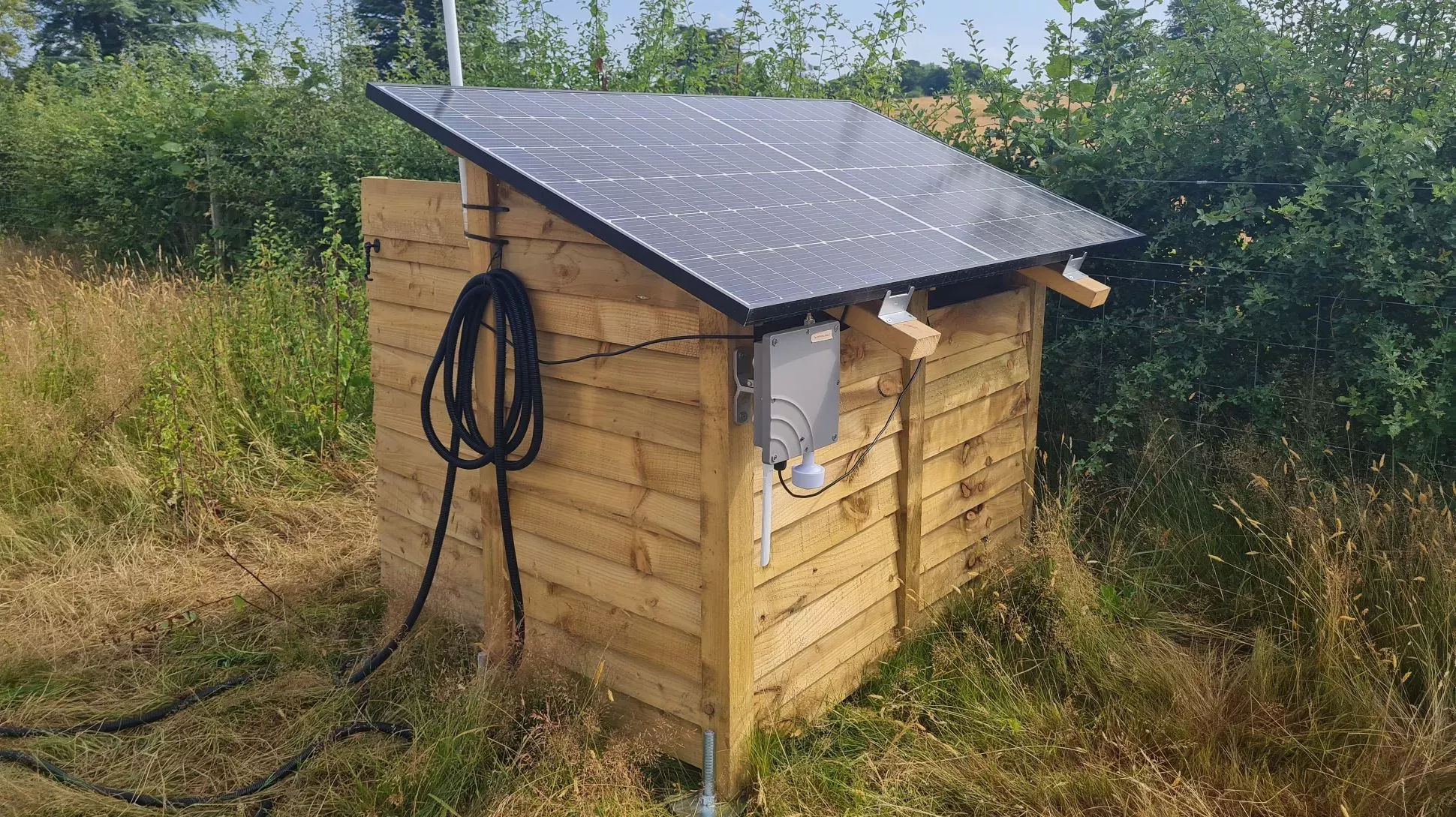 One of Gary’s log stores © RBG Kew A wooden shed with a black solar panel on the roof