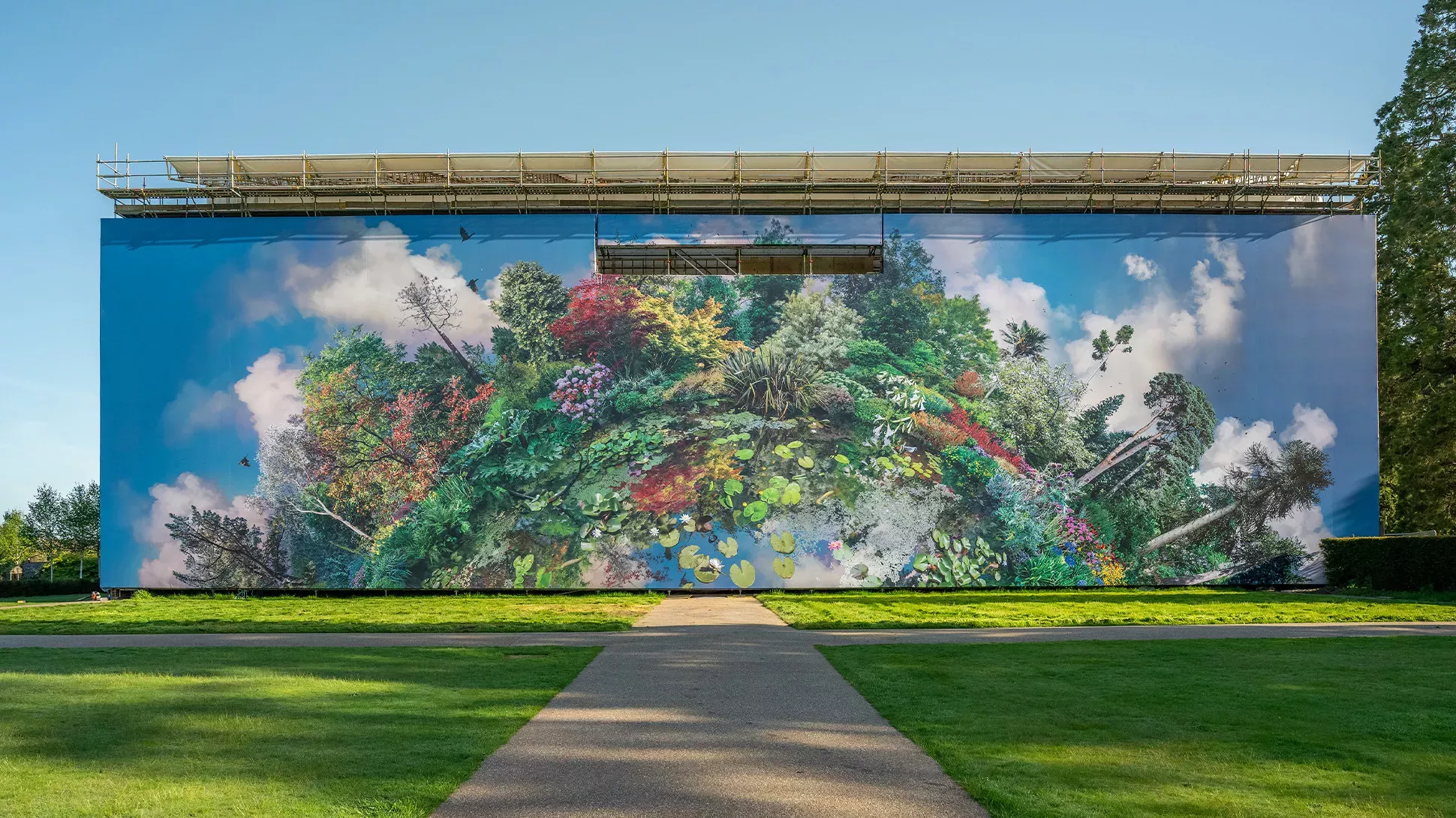 Planet Wakehurst, Visual Air © RBG Kew Giant artwork on the facade of a mansion, featuring a collage of plants and trees.