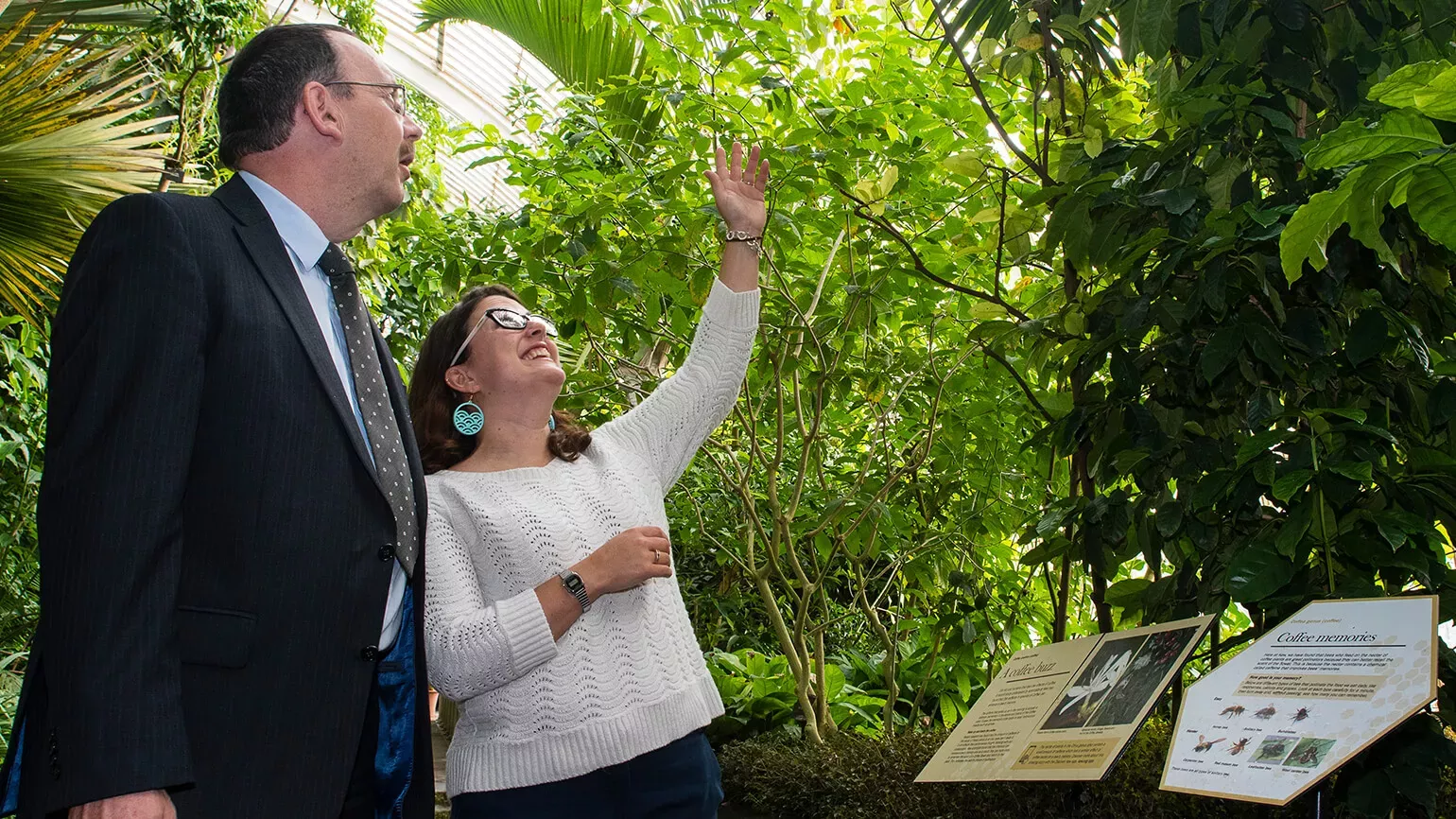 Partnership © RBG Kew. Researcher and corporate partner looking at plants
